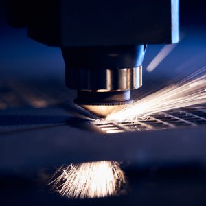 CNC Laser cutting of metal close up, modern industrial technology. Small depth of field.